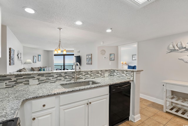 kitchen with decorative backsplash, dishwasher, open floor plan, white cabinetry, and a sink