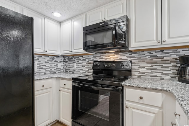 kitchen featuring decorative backsplash, white cabinets, light stone counters, a textured ceiling, and black appliances