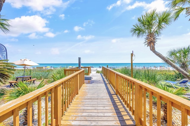 surrounding community featuring a water view and a beach view