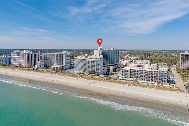 birds eye view of property featuring a view of the beach, a water view, and a city view