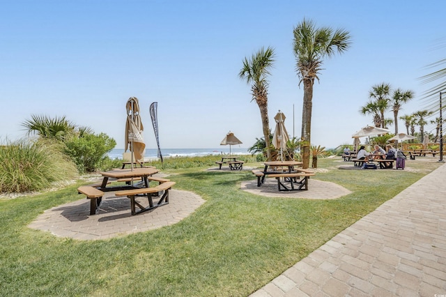 view of community featuring a water view and a lawn