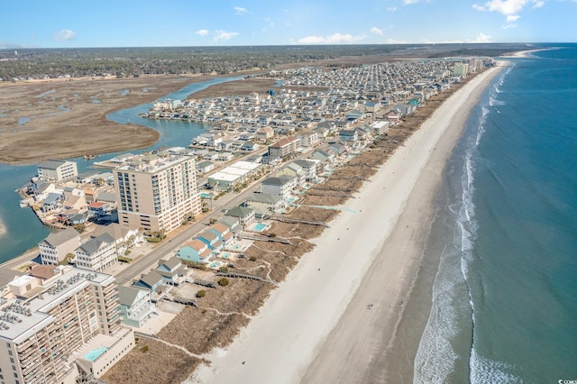 drone / aerial view with a city view, a beach view, and a water view