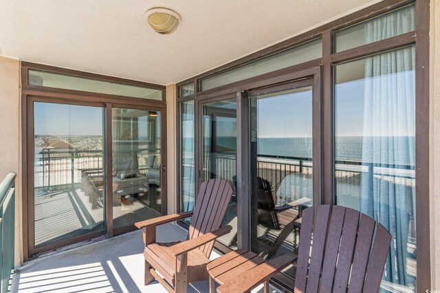 balcony featuring a water view