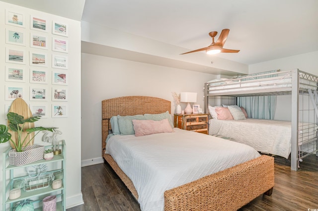 bedroom featuring dark wood finished floors, a ceiling fan, and baseboards