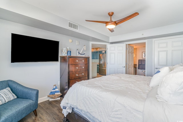 bedroom with baseboards, visible vents, stainless steel fridge with ice dispenser, dark wood-type flooring, and ensuite bathroom