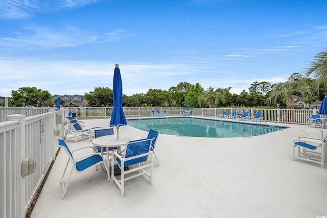 community pool featuring a patio area and fence