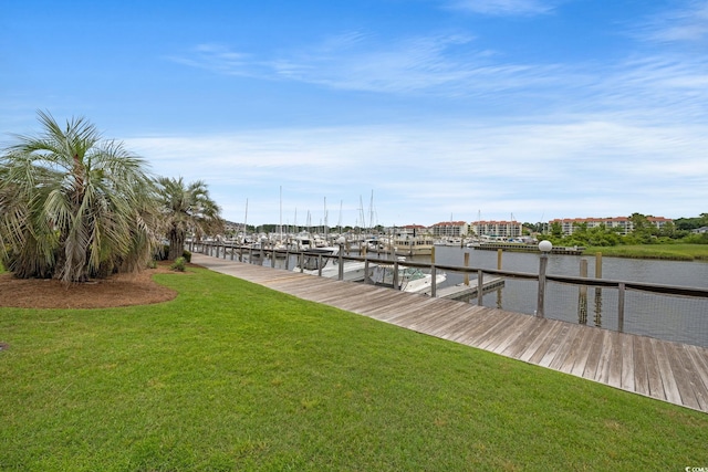 dock area featuring a lawn and a water view