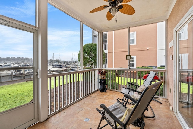 sunroom featuring a ceiling fan