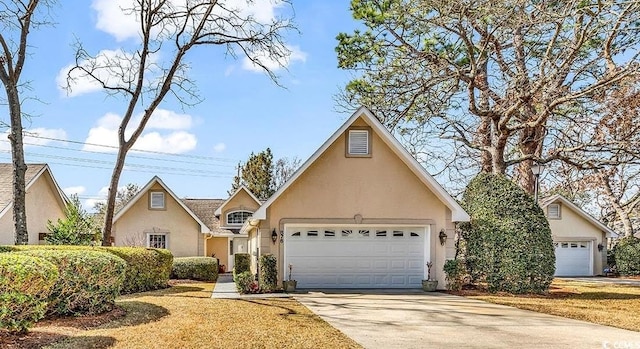 view of front of property featuring a garage, concrete driveway, and stucco siding