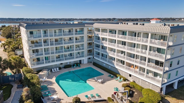 exterior space featuring fence and a community pool