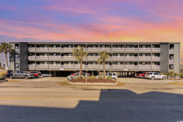 property at dusk with uncovered parking