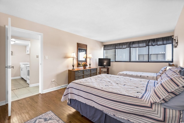 bedroom with baseboards and light wood finished floors