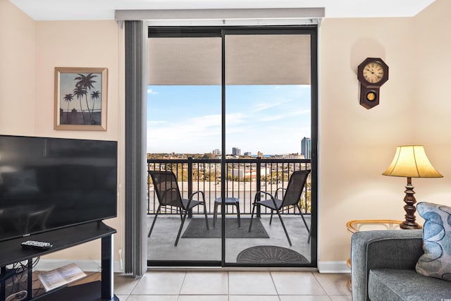 interior space featuring floor to ceiling windows, a city view, and light tile patterned flooring