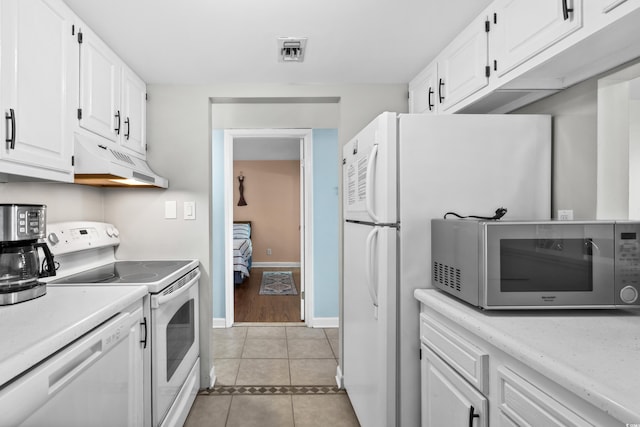 kitchen with light countertops, white appliances, white cabinets, and under cabinet range hood