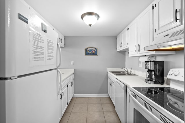 kitchen with light tile patterned flooring, under cabinet range hood, white appliances, white cabinets, and light countertops