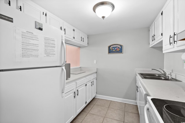 kitchen with light countertops, white appliances, a sink, and white cabinets