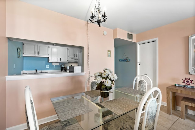 dining room featuring baseboards, visible vents, an inviting chandelier, and light tile patterned flooring