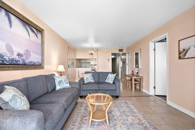 living area with light tile patterned flooring, visible vents, and baseboards