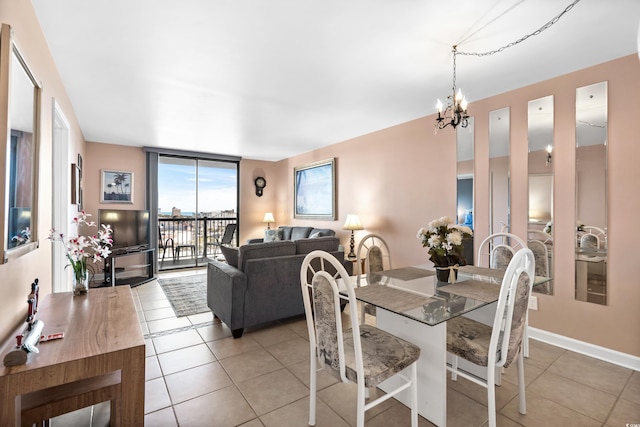 dining space with baseboards, tile patterned flooring, floor to ceiling windows, and a notable chandelier