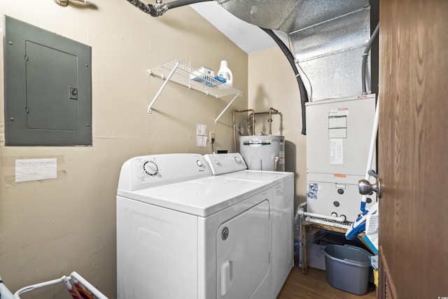 washroom with dark wood-style flooring, washing machine and clothes dryer, electric water heater, laundry area, and electric panel