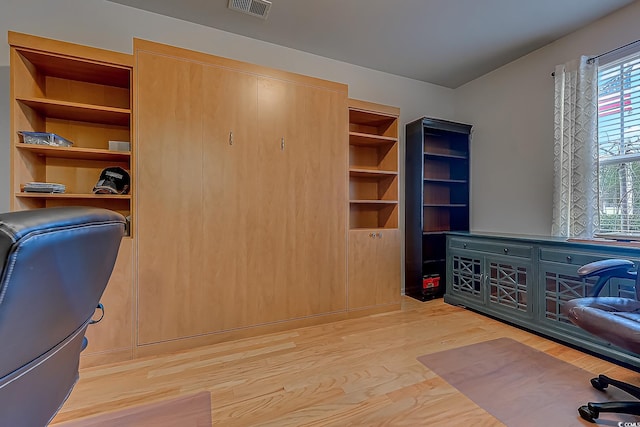 office area featuring light wood-style floors and visible vents