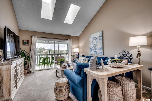 living room featuring a textured ceiling, carpet floors, a skylight, and high vaulted ceiling