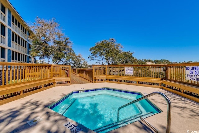 view of pool featuring a hot tub and a wooden deck