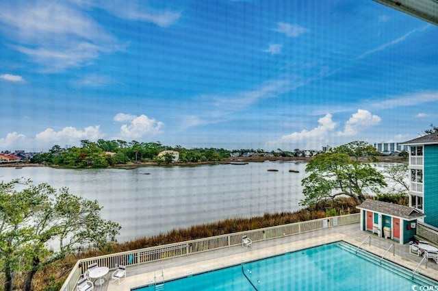 pool featuring a water view and fence