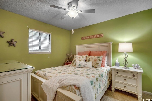 bedroom featuring a ceiling fan, light carpet, and a textured ceiling