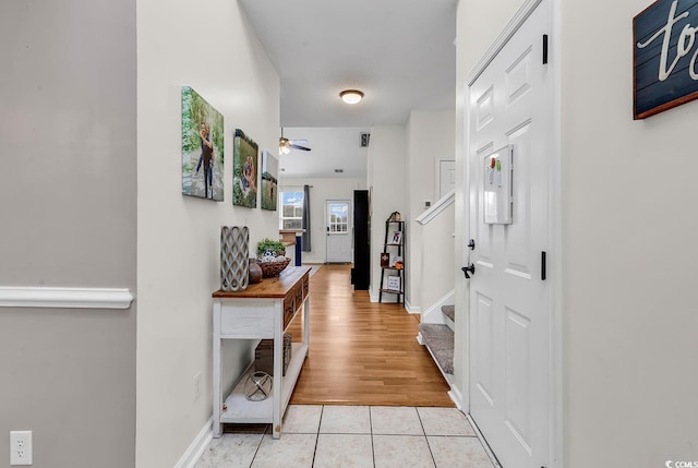 entryway with ceiling fan, stairway, light tile patterned flooring, and baseboards