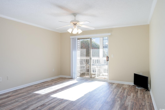 empty room featuring baseboards, ceiling fan, wood finished floors, crown molding, and a textured ceiling