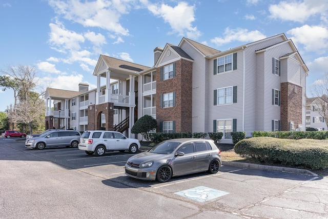 view of building exterior featuring uncovered parking