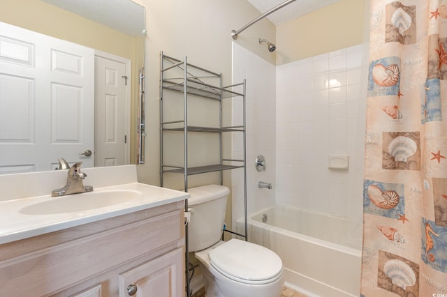 full bath with a textured ceiling, shower / bath combination with curtain, vanity, and toilet