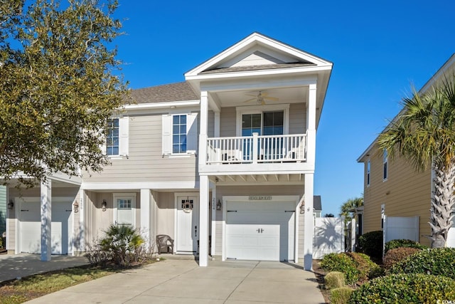 view of front of property featuring driveway, a shingled roof, a balcony, ceiling fan, and an attached garage