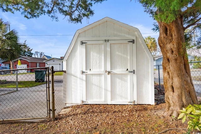 view of shed with a gate and fence