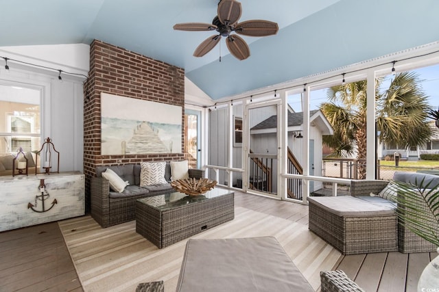 sunroom featuring lofted ceiling and ceiling fan