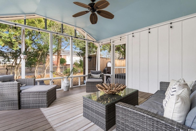 sunroom featuring lofted ceiling and ceiling fan