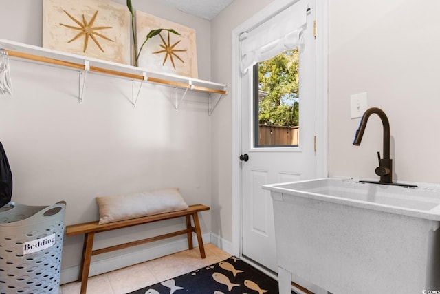 interior space featuring light tile patterned floors and baseboards