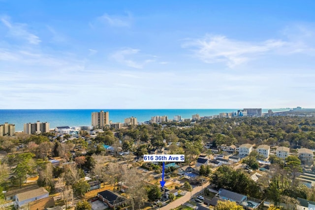 birds eye view of property with a water view and a view of city