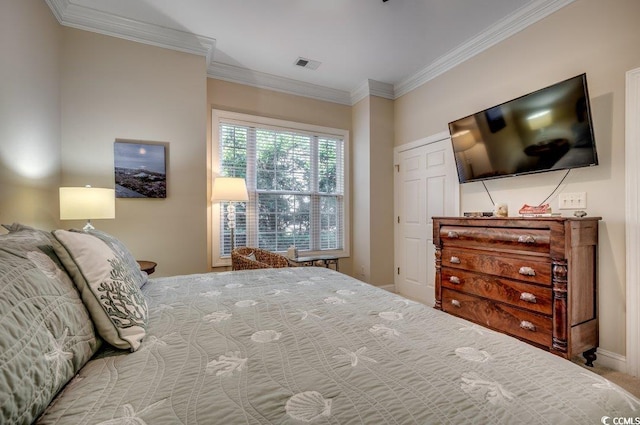 carpeted bedroom with baseboards, visible vents, and crown molding