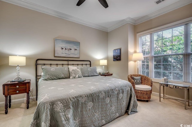 carpeted bedroom featuring baseboards, ceiling fan, visible vents, and crown molding