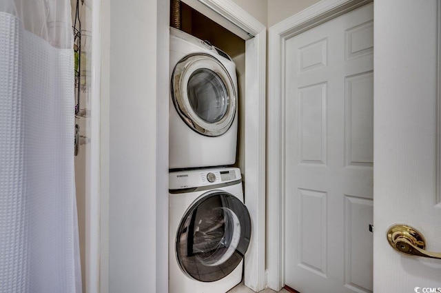 laundry room with stacked washer and dryer and laundry area