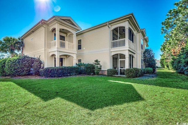 view of front of property with a front lawn and a balcony