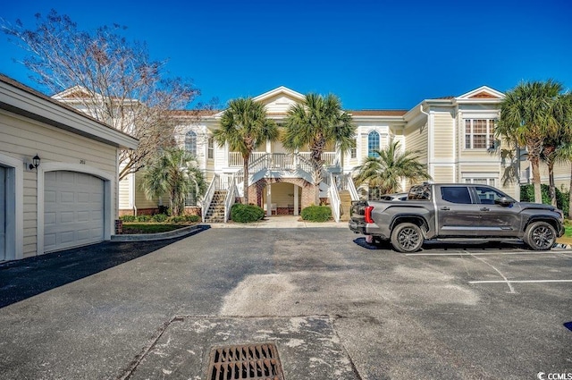 view of property featuring stairs and a garage