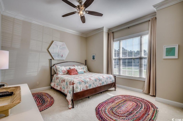 bedroom with ornamental molding, light colored carpet, ceiling fan, and baseboards