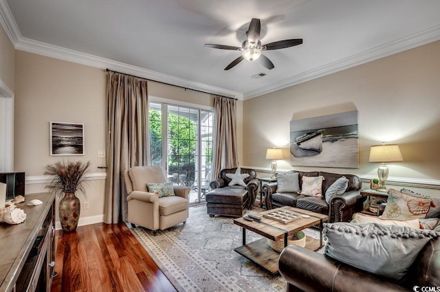 living room with crown molding, visible vents, dark wood-type flooring, ceiling fan, and baseboards