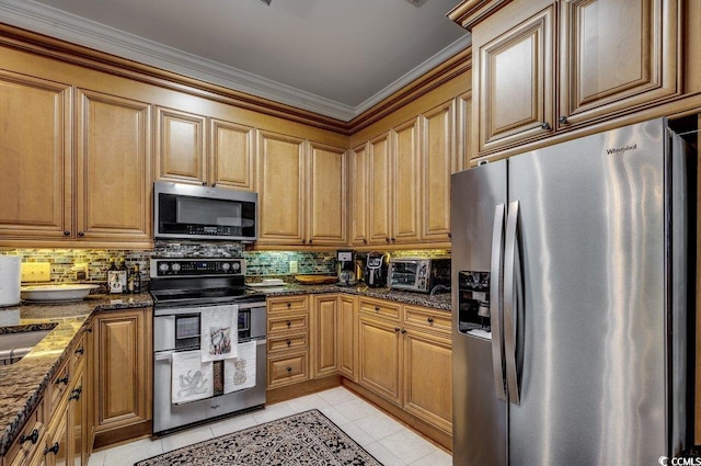 kitchen featuring light tile patterned floors, tasteful backsplash, stainless steel appliances, and dark stone countertops