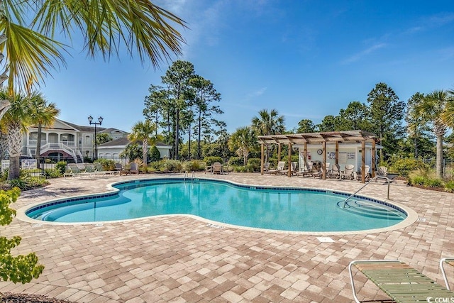 community pool with fence and a patio