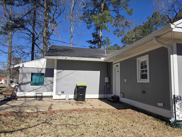 back of property featuring a patio and stucco siding