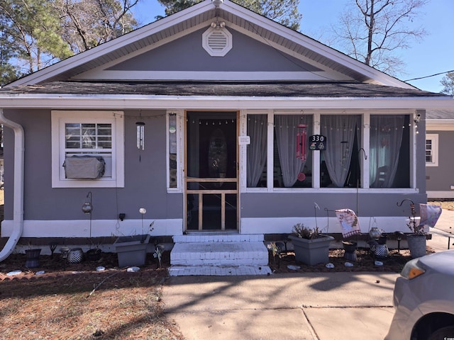 view of front of home featuring a shingled roof and entry steps